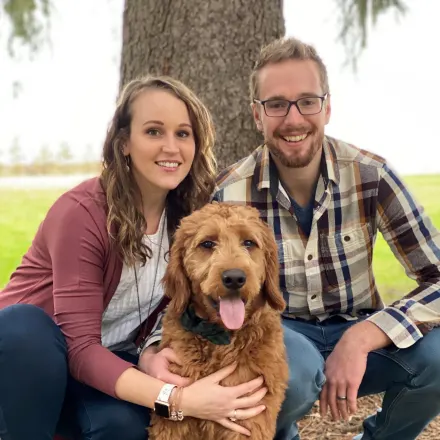 Dr. Alyssa Smith's staff photo from North Lake Veterinary Clinic where she's posing with her husband and pet dog at a park